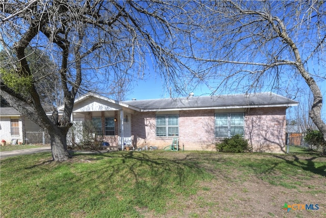 single story home with a front lawn and brick siding