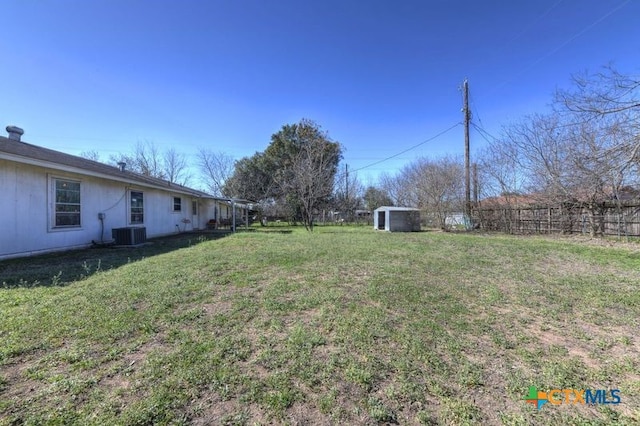 view of yard with fence and central air condition unit