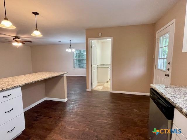 1541 Cologne Dr, New Braunfels, TX 78130 - kitchen with stainless steel dishwasher, white cabinetry, baseboards, and a wealth of natural light