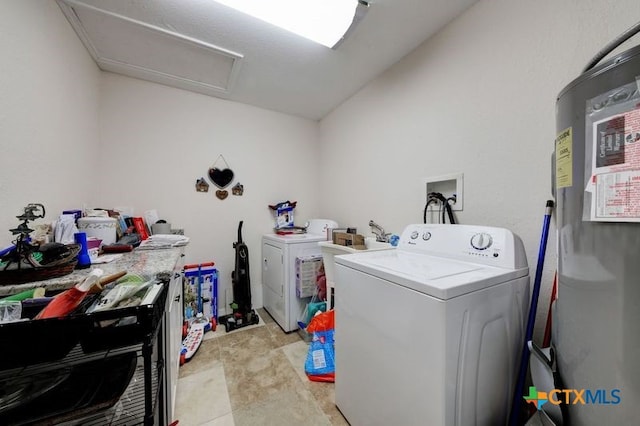 laundry area featuring attic access, washing machine and dryer, laundry area, and a sink