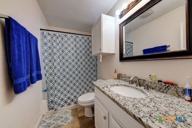 full bathroom featuring vanity, toilet, and a textured ceiling