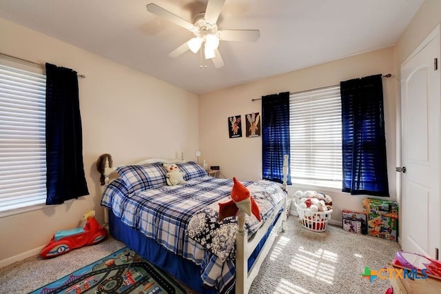 bedroom with a ceiling fan and baseboards