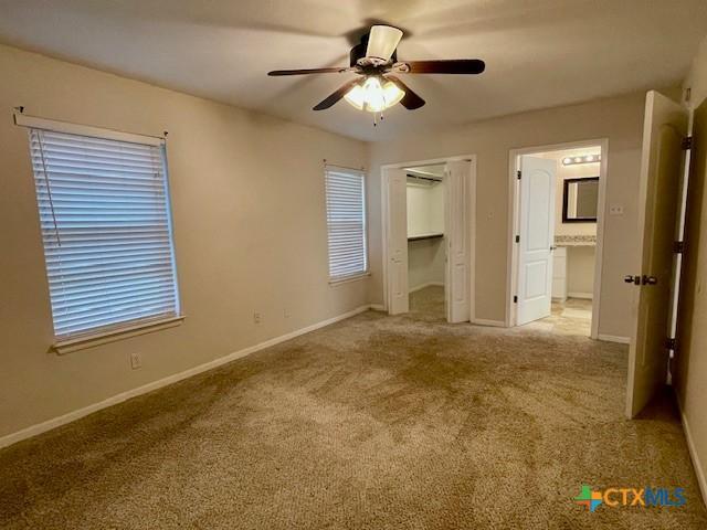 1541 Cologne Dr, New Braunfels, TX 78130 - unfurnished bedroom featuring carpet floors, baseboards, and a ceiling fan