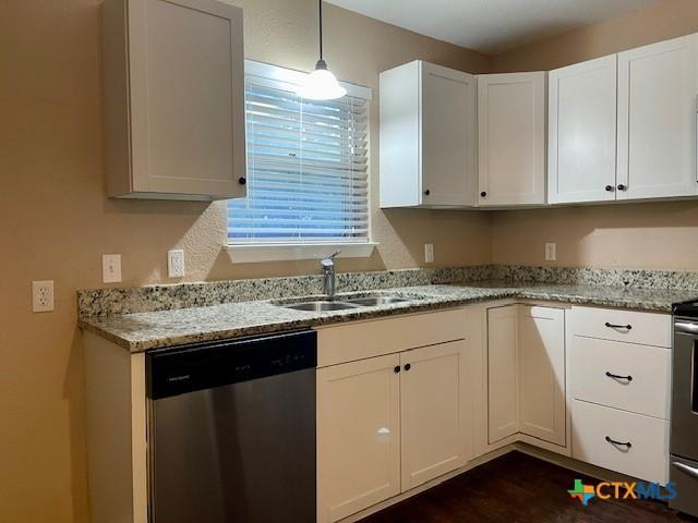 1541 Cologne Dr, New Braunfels, TX 78130 - kitchen with a sink, pendant lighting, white cabinets, dishwasher, and light stone counters