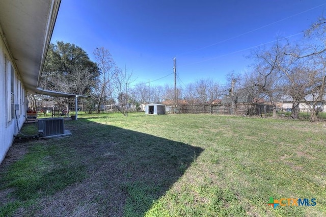 view of yard with a fenced backyard, a storage unit, cooling unit, and an outdoor structure