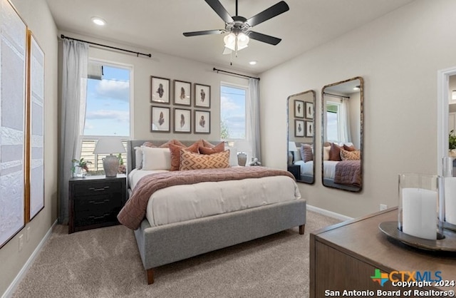 carpeted bedroom with ceiling fan