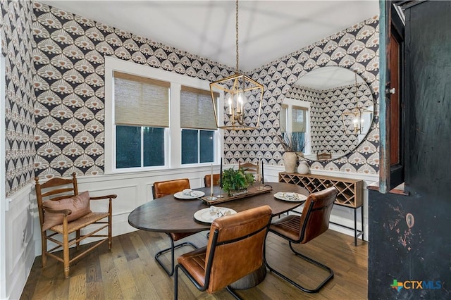 dining space featuring hardwood / wood-style floors and a notable chandelier