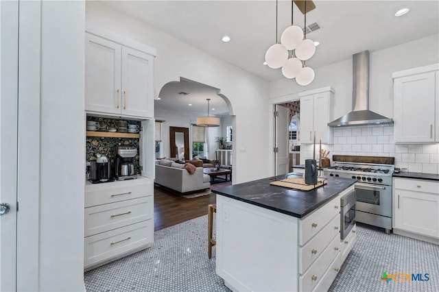 kitchen with white cabinetry and wall chimney exhaust hood