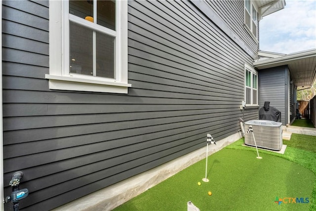 view of side of home featuring central AC unit