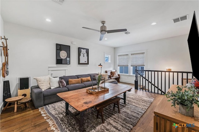 living room with ceiling fan and hardwood / wood-style floors