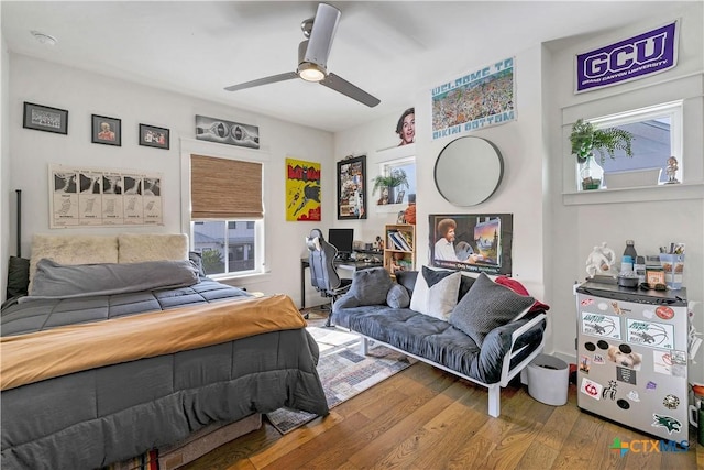 bedroom with hardwood / wood-style floors and ceiling fan