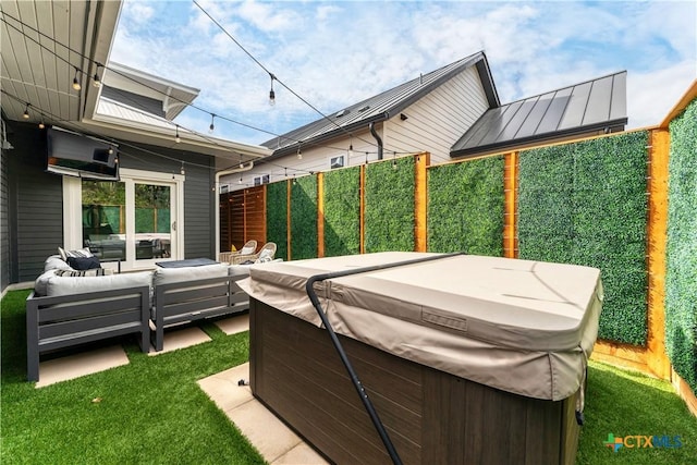 view of patio / terrace featuring a hot tub and an outdoor living space