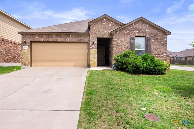 ranch-style home with brick siding, driveway, a front yard, and a garage