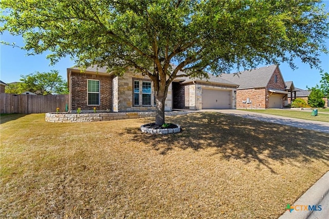 view of front of house with a garage, stone siding, fence, a front lawn, and concrete driveway