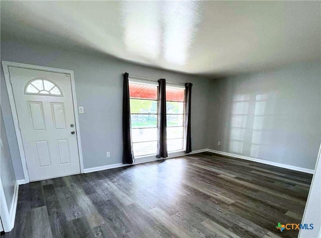 1818 Travis Ave, Victoria, TX 77901 - foyer entrance featuring dark wood finished floors and baseboards