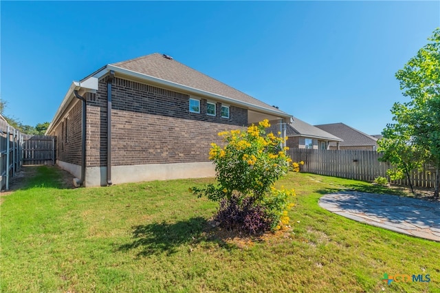 view of property exterior with a patio and a yard