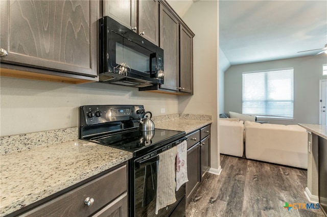 kitchen with dark brown cabinetry, black appliances, light stone countertops, ceiling fan, and dark wood-type flooring