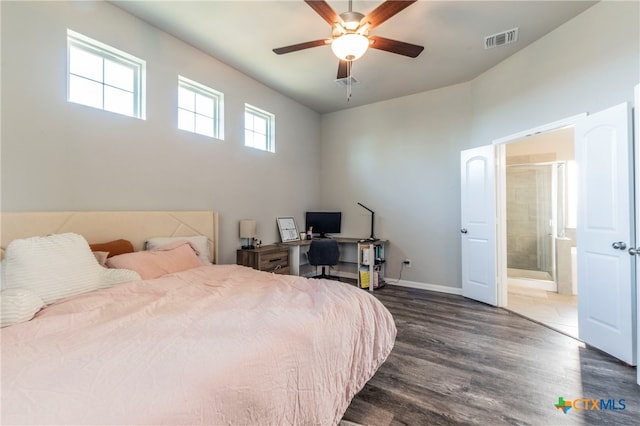 bedroom with ensuite bath, ceiling fan, and dark hardwood / wood-style floors