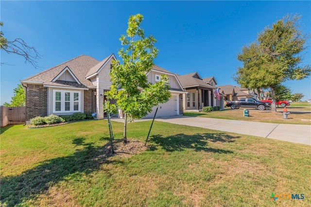 view of front of property featuring a garage and a front yard