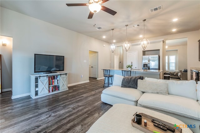 living room featuring dark hardwood / wood-style flooring and ceiling fan