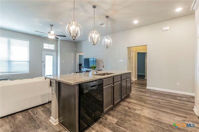 kitchen with pendant lighting, sink, dishwasher, dark brown cabinets, and a center island with sink