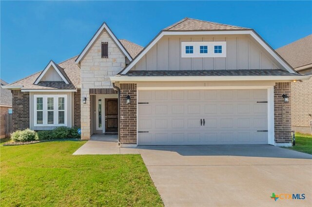 view of front of property with a lawn and a garage