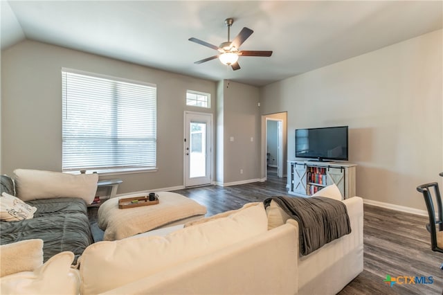 living room featuring lofted ceiling, dark hardwood / wood-style floors, and ceiling fan