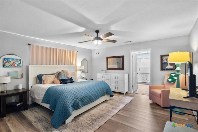 119 Larimore St, Victoria, TX 77904 - bedroom with wood finished floors, a ceiling fan, and ensuite bath