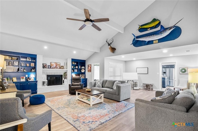 119 Larimore St, Victoria, TX 77904 - living room with ceiling fan, wood finished floors, a fireplace, and recessed lighting
