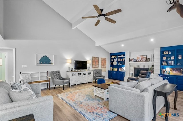 119 Larimore St, Victoria, TX 77904 - living area featuring a brick fireplace, beam ceiling, ceiling fan, wood finished floors, and high vaulted ceiling
