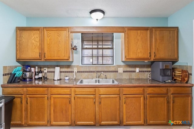 kitchen with sink, backsplash, and a textured ceiling