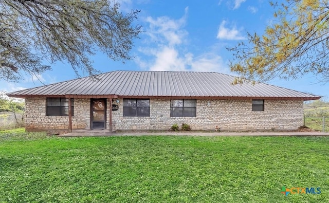 rear view of house featuring a lawn