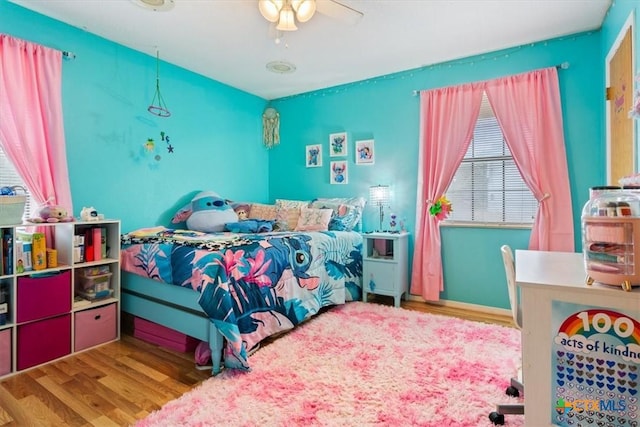 bedroom featuring hardwood / wood-style floors and ceiling fan