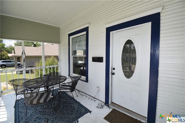 view of exterior entry featuring a porch