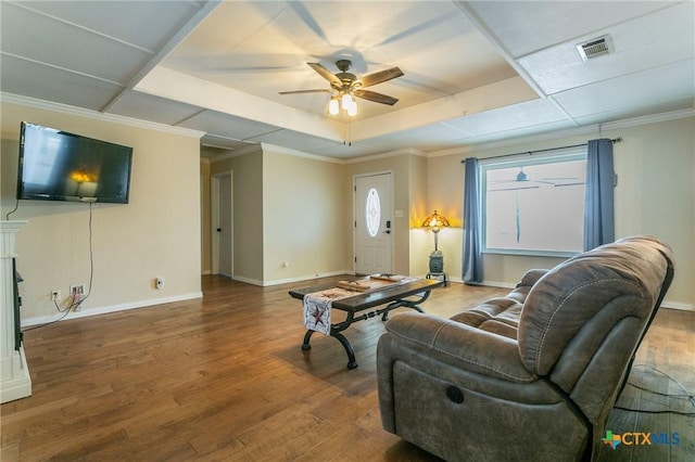 living room featuring hardwood / wood-style flooring, ornamental molding, a raised ceiling, and ceiling fan