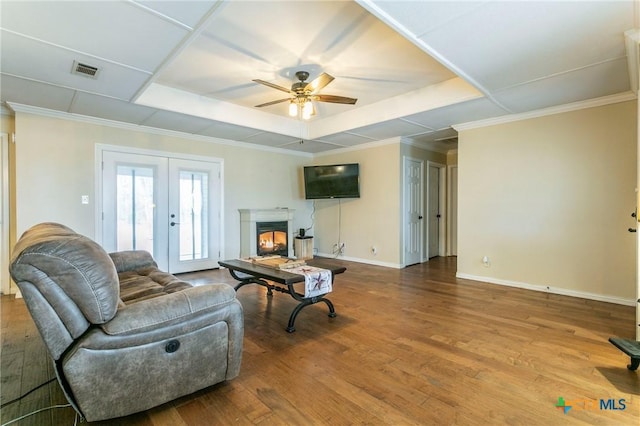 13230 Harvest Hill Ln, Holland, TX 76534 - living room featuring french doors, ornamental molding, a raised ceiling, ceiling fan, and hardwood / wood-style floors