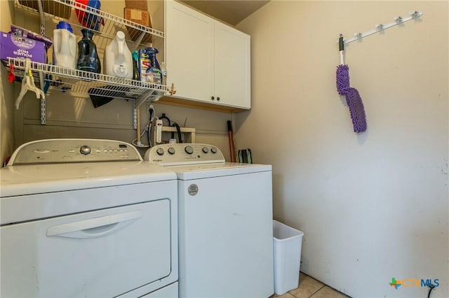 13230 Harvest Hill Ln, Holland, TX 76534 - laundry area with cabinets, light tile patterned floors, and washing machine and clothes dryer