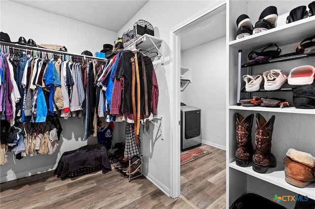 spacious closet with washer / clothes dryer and wood-type flooring