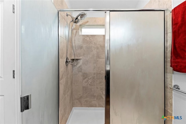 bathroom featuring a shower with door