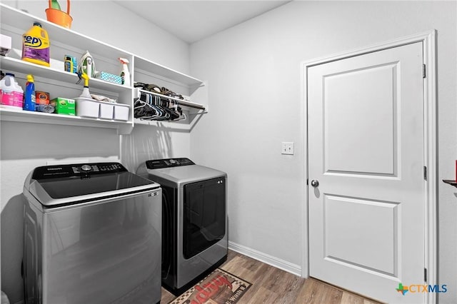 laundry room featuring washer and clothes dryer and hardwood / wood-style floors