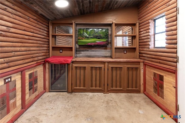 interior space with rustic walls, wood ceiling, and vaulted ceiling