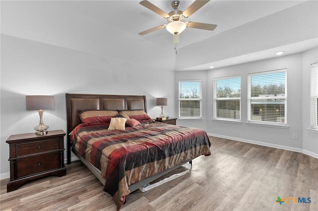 bedroom featuring light wood-type flooring, ceiling fan, and lofted ceiling