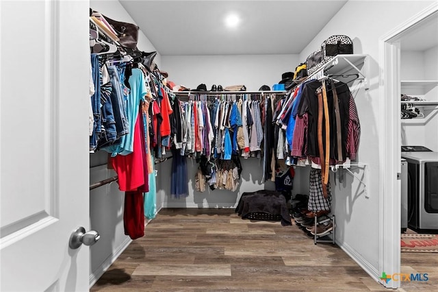 walk in closet featuring hardwood / wood-style flooring and washer / clothes dryer