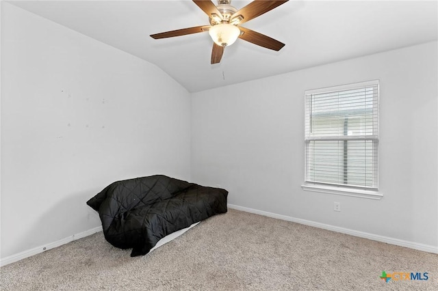 bedroom featuring ceiling fan, light carpet, and vaulted ceiling