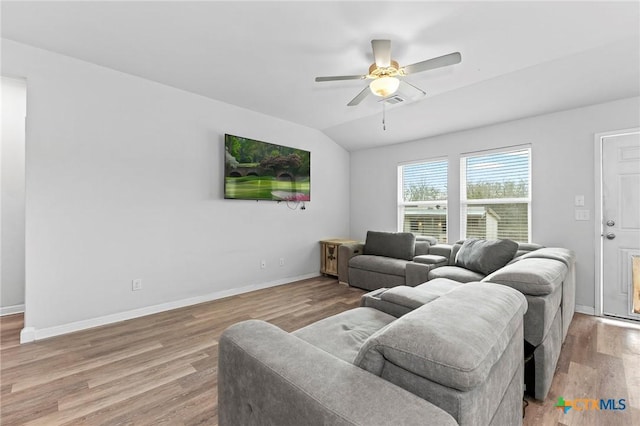 living room with ceiling fan, hardwood / wood-style floors, and lofted ceiling