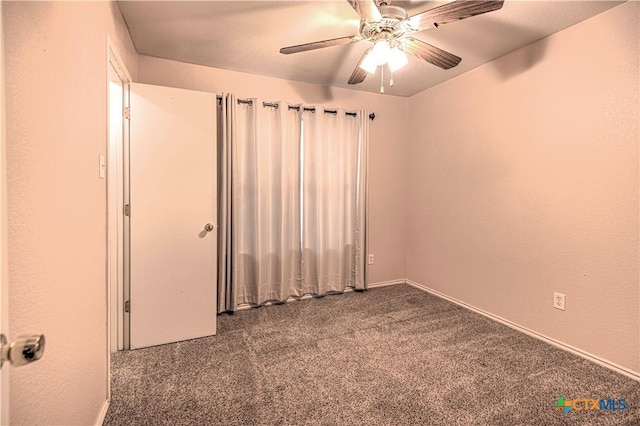 spare room featuring carpet floors and ceiling fan