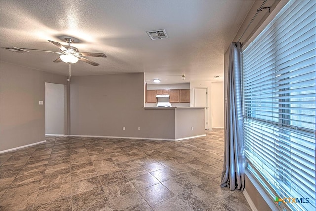 unfurnished room featuring a textured ceiling and ceiling fan