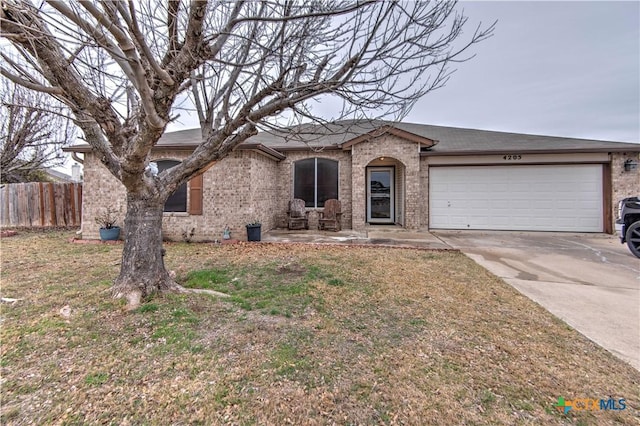 ranch-style house featuring a garage and a front lawn