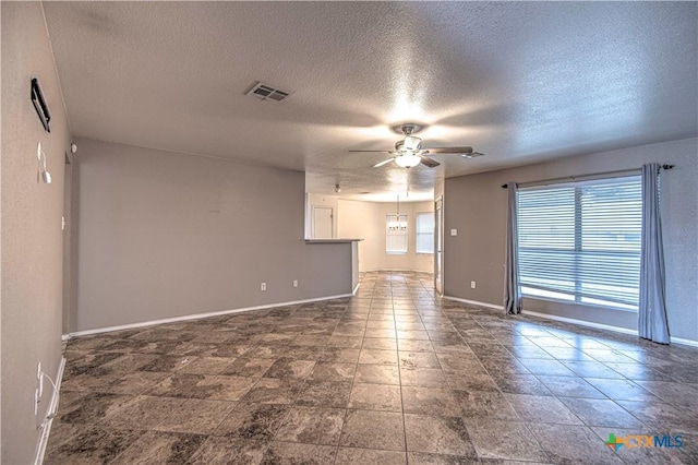 spare room with ceiling fan and a textured ceiling