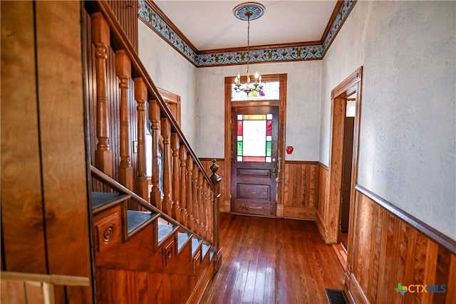 foyer with a chandelier and dark hardwood / wood-style floors